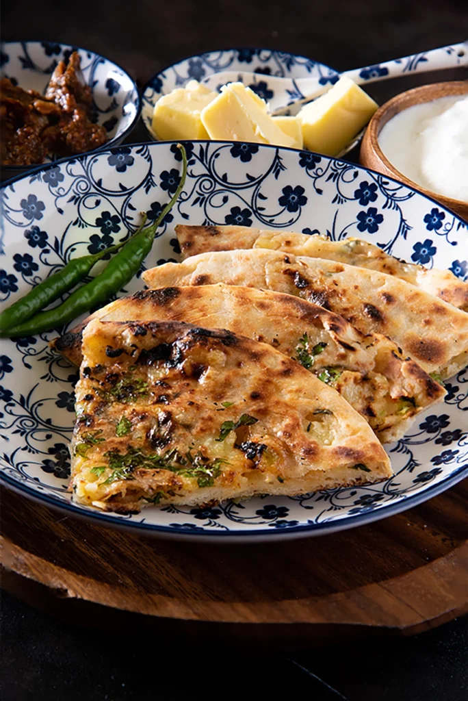 Amritsari Kulcha recipe: Crispy spicy aloo kulcha made on tawa.
