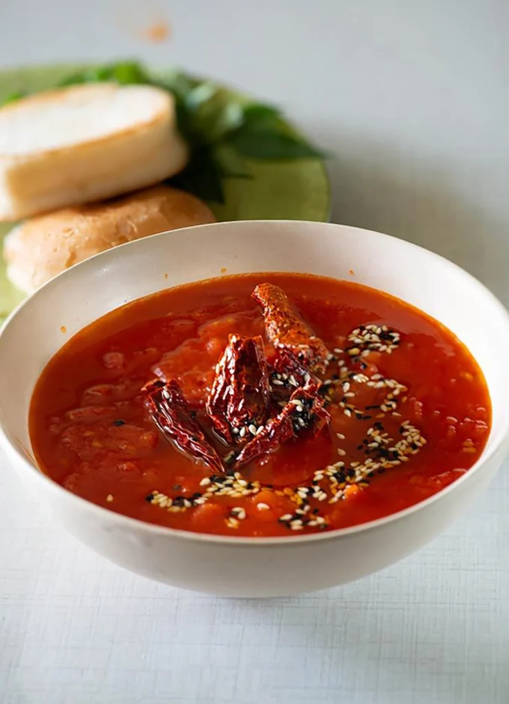 Spicy tomato chutney served in a bowl with bread